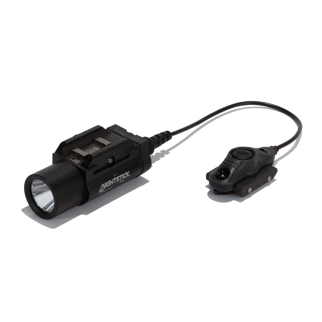 Black flashlight with attached remote control on a white background