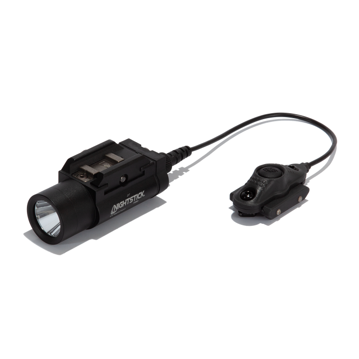 Black flashlight with attached remote control on a white background