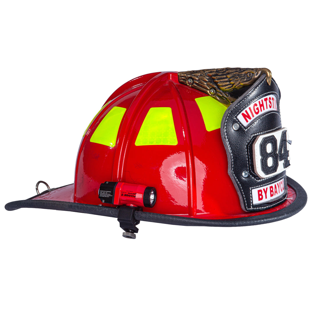 Red fire helmet with reflective yellow windows and a badge on a white background