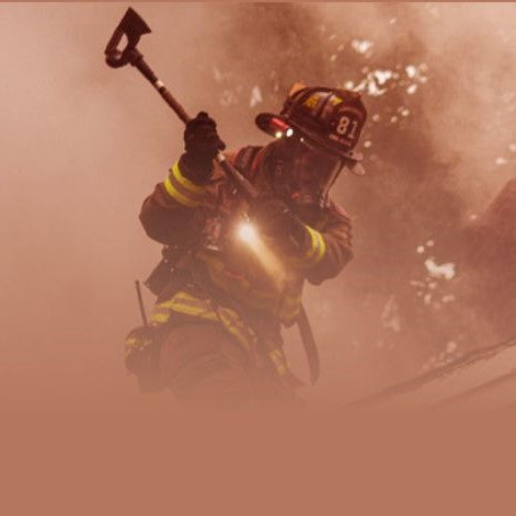 Firefighter in action with an axe during a fire