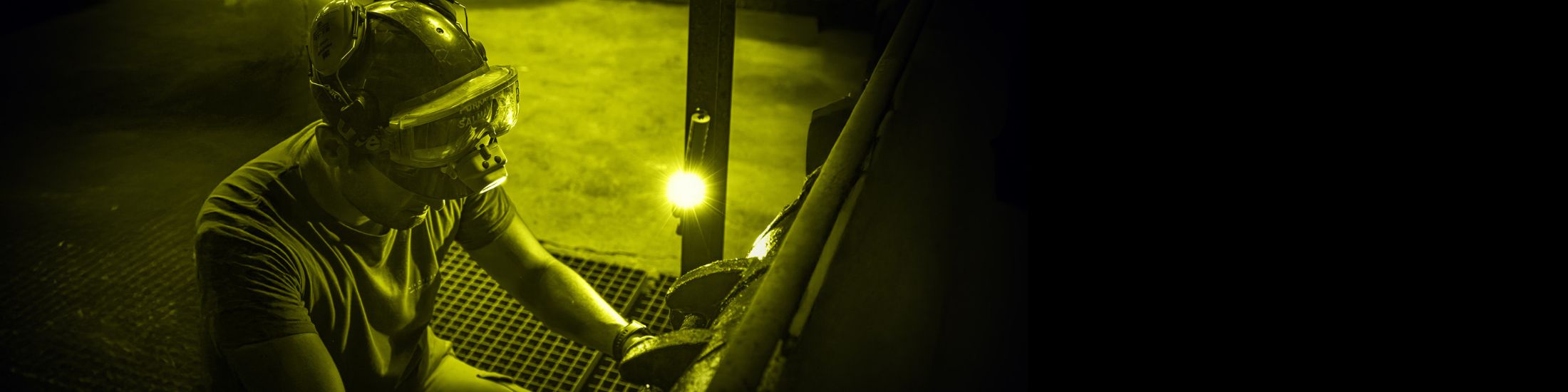 workman using Nightstick headlamp to light up his work area
